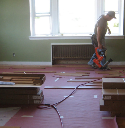 Room before the interior renovation, showing old flooring and unpainted walls.